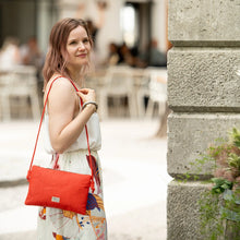 Load image into Gallery viewer, Woman holding a red bag made from pineapple leaves

